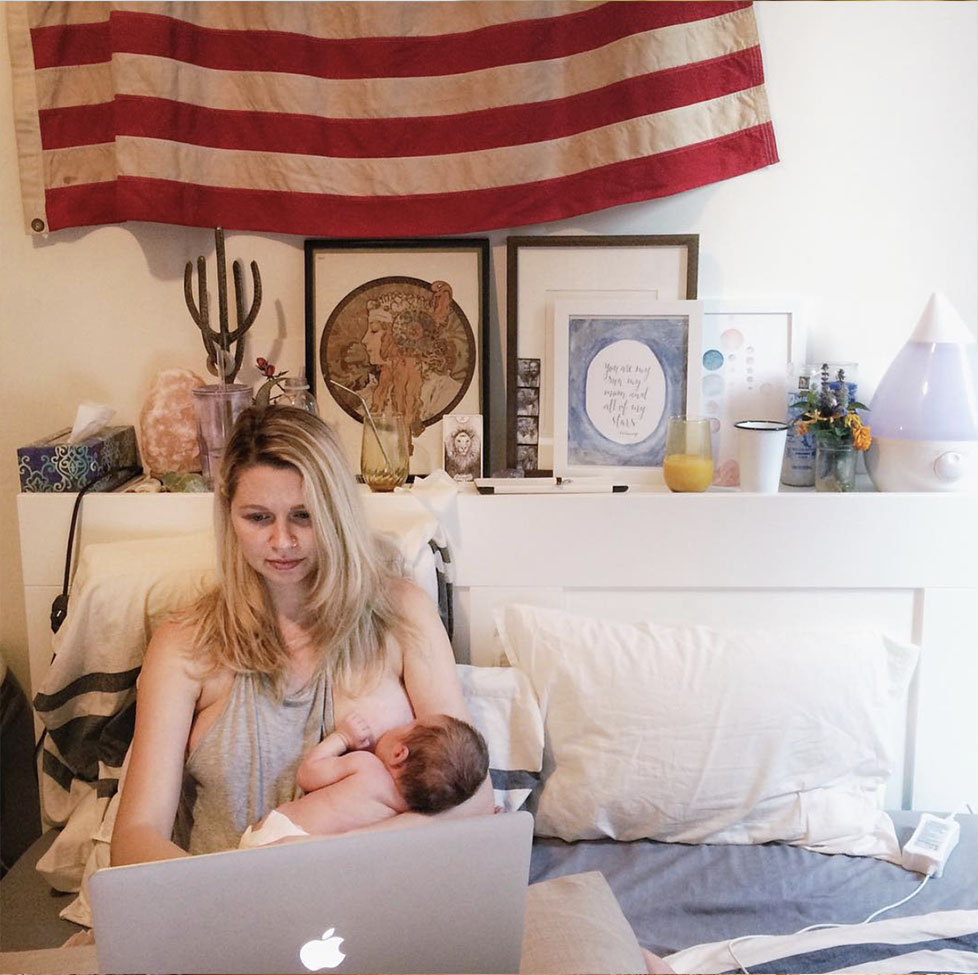 breastfeeding mother working on laptop